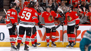 Photos shows Chicago Blackhawks players discussing after a play at the United Center in Chicago.